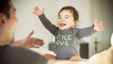 A smiling baby, progressing through the stages of infant development