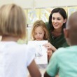 A child presenting one of her adoption-related school assignments