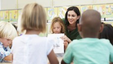 A child presenting one of her adoption-related school assignments