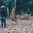 Two siblings play together in the yard after being adopted.