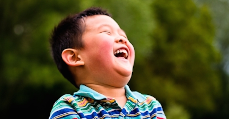 A laughing child who joined his family through Taiwan adoption