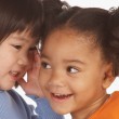 Two preschool girls engaging in make-believe