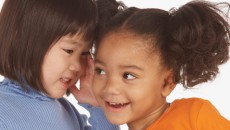 Two preschool girls engaging in make-believe