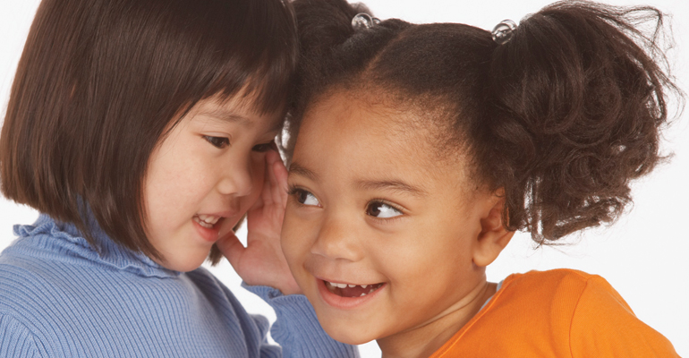 Two preschool girls engaging in make-believe