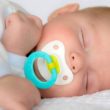 Infant baby boy sleeping peacefully with pacifier