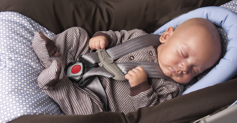 A baby boy whose parents are traveling to adopt him