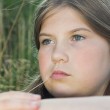 Puberty in adopted children can be especially difficult, as demonstrated by this melancholy girl in a field