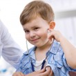 A child getting a doctor's exam, covered by health insurance