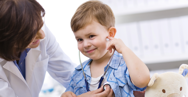 A child getting a doctor's exam, covered by health insurance