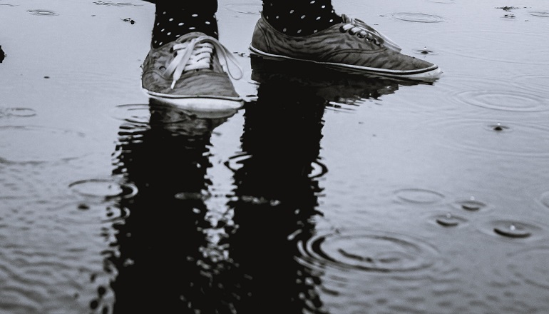 A pair of sneakers on a rainy day