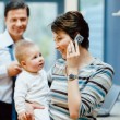 A family in an open adoption talks to birth parents on the phone