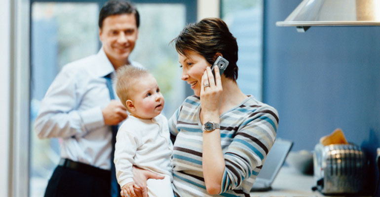 A family in an open adoption talks to birth parents on the phone