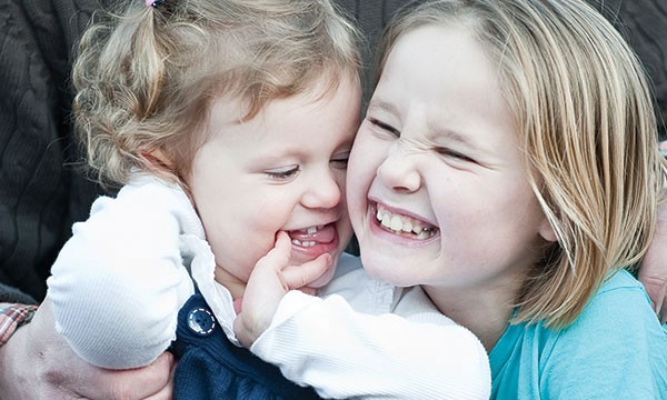 Young girls playing with their birth father.