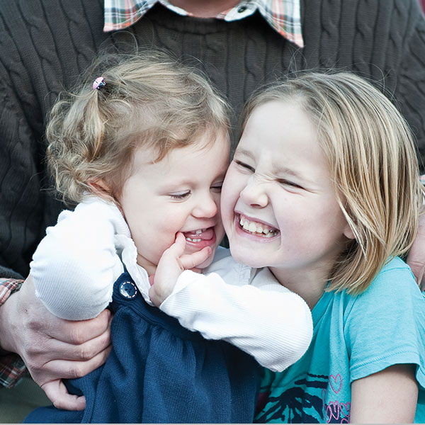 Young girls playing with their birth father.