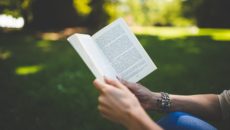 A woman reading adoption books for parents