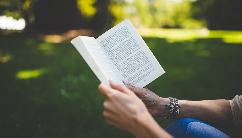 A woman reading adoption books for parents