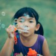 A girl blows bubbles and thinks about transracial families.