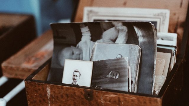 A box of old photographs that show family resemblance