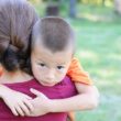 A mother comforting a child who was exposed to violence