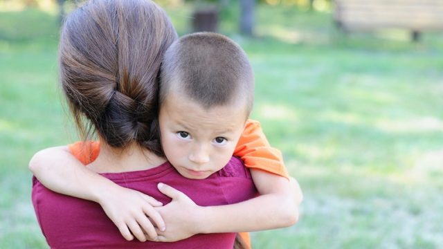 A mother comforting a child who was exposed to violence