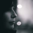 A woman looks into the distance and thinks about the stages of adoption