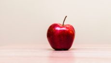 An apple on a teacher's desk who was explaining adoption.