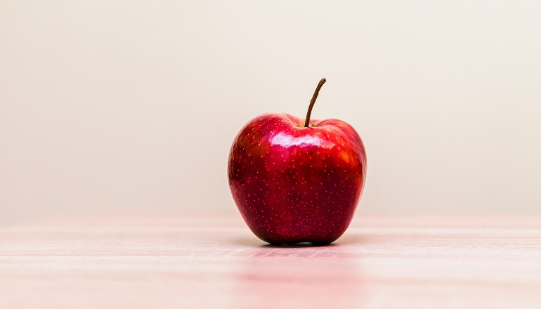 An apple on a teacher's desk who was explaining adoption.