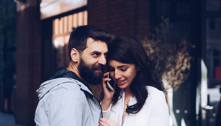 Two prospective adoptive parents listen to a phone call that they received a match.