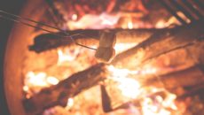 A child toasts marshmallows at culture camp