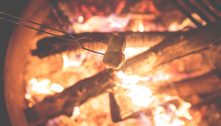 A child toasts marshmallows at culture camp