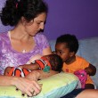 A woman with her children after adoptive breastfeeding.