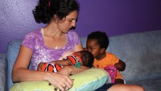 A woman with her children after adoptive breastfeeding.