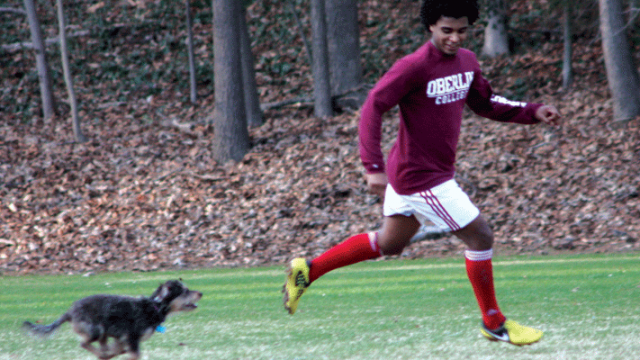 Family picture of Melissa Fay Greene's son, Fisseha "Sol" Samuel, running with his dog, Bodie.