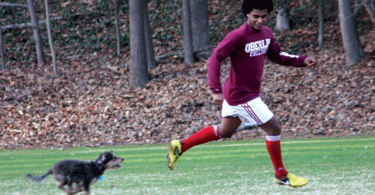 Family picture of Melissa Fay Greene's son, Fisseha "Sol" Samuel, running with his dog, Bodie.