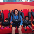 A family at a theme park for their summer adoption plans