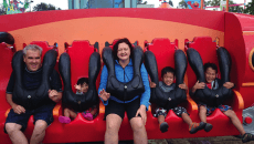 A family at a theme park for their summer adoption plans
