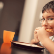 A child eating and overcoming food insecurity