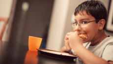 A child eating and overcoming food insecurity