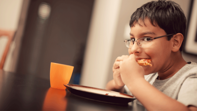 A child eating and overcoming food insecurity