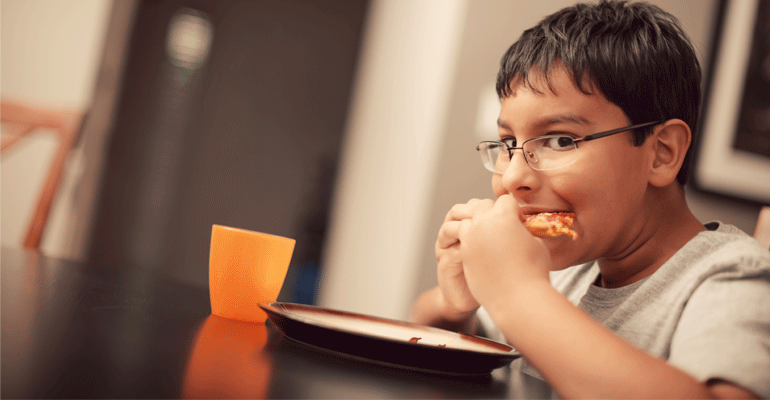 A child eating and overcoming food insecurity