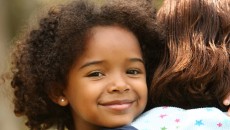 A young girl smiling to learn foster adoption facts