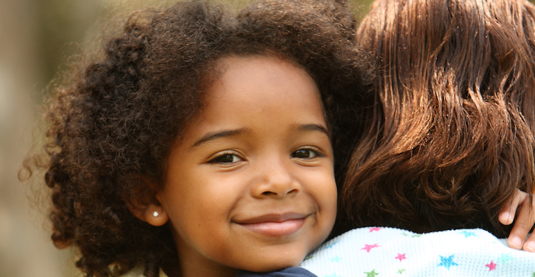 A young girl smiling to learn foster adoption facts