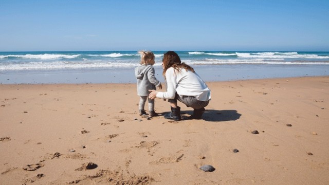 A mom of an adopted child, on the beach with that adopted child