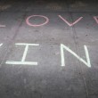 "Love wins" in chalk, representing the victories of LGBT marriage and same-sex adoptions