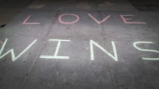 "Love wins" in chalk, representing the victories of LGBT marriage and same-sex adoptions