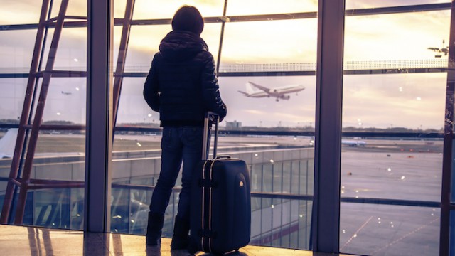 A woman at an airport, adopting while pregnant