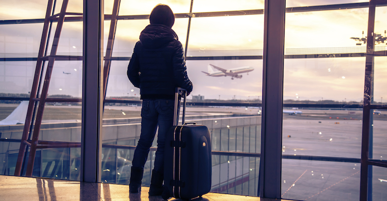 A woman at an airport, adopting while pregnant