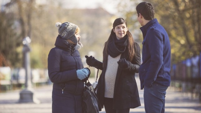 A couple meeting with a pregnant woman, hoping to have a positive expectant mother match