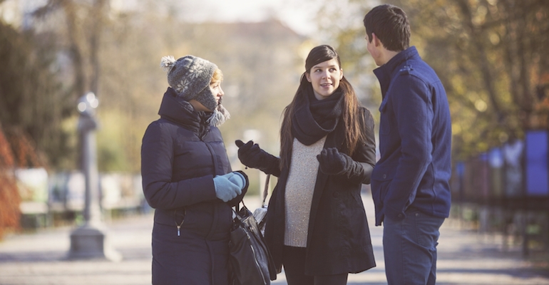 A couple meeting with a pregnant woman, hoping to have a positive expectant mother match