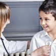 A pediatrician utilizing new health care guidelines for foster children on a small boy